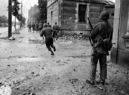 Street fighting, Cherbourg. These G.I.'s are from Martinez's 79th Division.