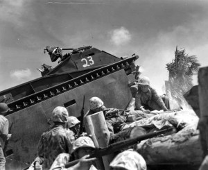 Marines use an amphibious tractor for cover on the beach at Betio Island, Tarawa.
