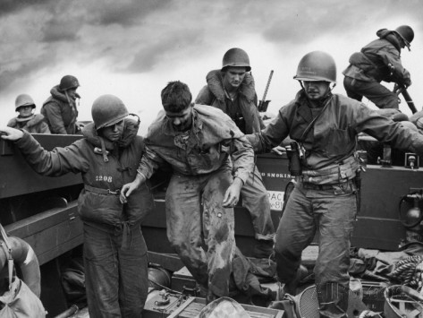 us-coast-guardsmen-assisting-a-wounded-marine-returning-from-the-fight-on-iwo-jima